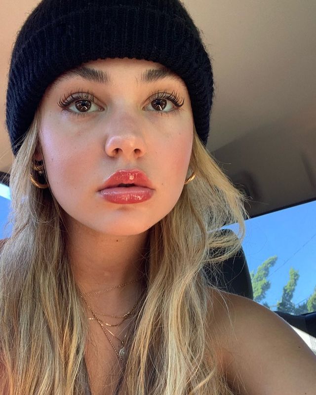 Photo of Olivia Darin wearing a black cap with blond hair